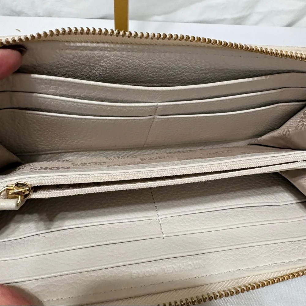 Michael Kors Moxley continental zip-around wallet in vanilla or cream leather.